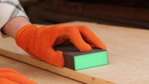 The process of sanding a wooden surface with a sanding block Vídeo Stock 335475543