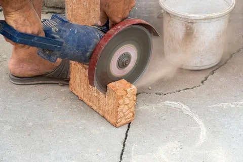 The process of sawing bricks with a grinder with a diamond disc Stock Photos
