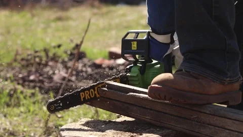 The process of sawing dry wood using a Procraft chainsaw Stock Footage 335283418