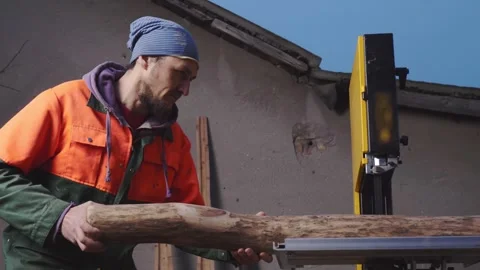 The process of sawing a processed log into halves on a machine to make a tool Stock Footage 244990614
