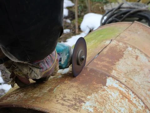 The process of sawing tin with a grinder Stock Photos