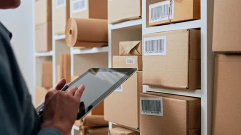 The process of scanning the accounting of parcels. An employee in overalls s Video stock 222587900