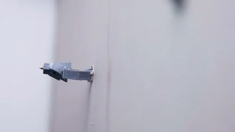 Process of screw fixation with plastic dowel in plasterboard hole, electric Stock-Footage 268700958