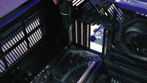 Process of screwing motherboard inside the computer case Stock Footage 328985757