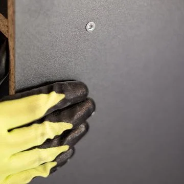 The process of screwing the screw, installation of a sliding door wardrobe. 스톡 사진