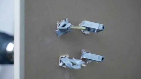 Process of screws fixation in drywall holes with plastic dowels, electric Stock Footage 268621201