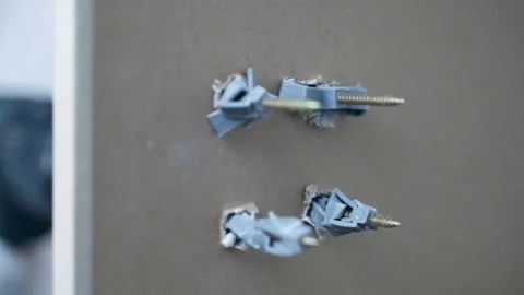 Process of screws fixation in drywall holes with plastic dowels, electric Stock-Footage 302101338