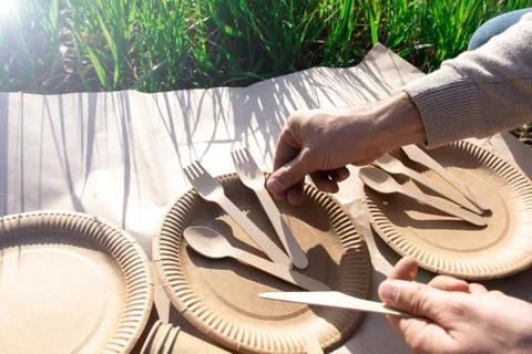 The process of serving biodegradable disposable tableware at a picnic. Stock Photos