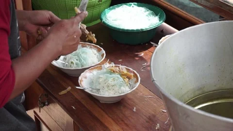 The process of serving Lamongan Chicken Soto Stock Footage 210373925