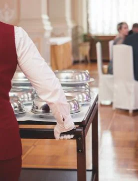 Process of serving luxury dinner in a cloche plate dish with a lid, waiter se Stock Photos