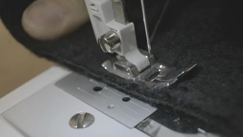 The process of sewing black woolen fabric on the sewing machine Stock Footage 114622652