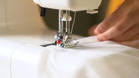 The process of sewing curtains from a mesh of white fabric. Close up view. Stock Footage 128236947