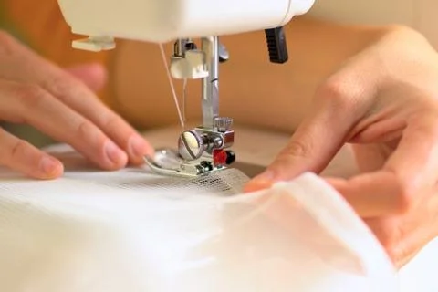 The process of sewing curtains from a mesh of white fabric. Close up view. Foto stock