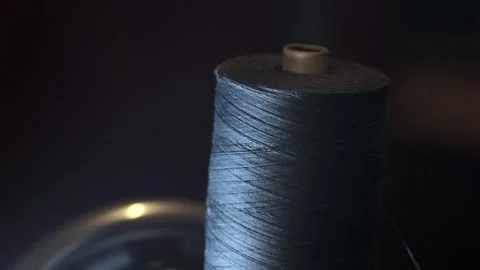 Process of sewing fabric. Closeup skein of black thread on a working retro Stock Footage 295931100