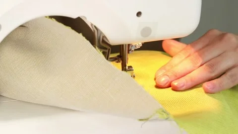 The process of sewing fabric on a sewing machine, The sewing machine Stock Footage 274587412