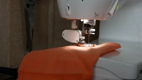 Process of sewing orange fabric Stock Footage 140251066