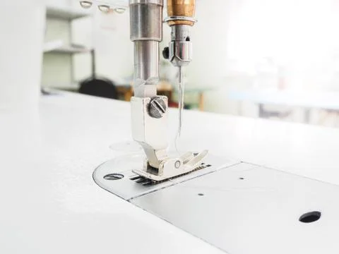 The process of sewing on the overlock in the garment shop. Stock Photos