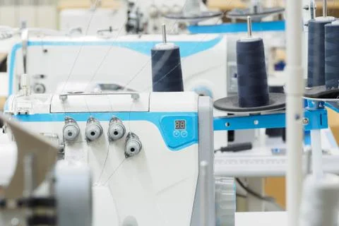 The process of sewing on the overlock in the garment shop. Stock Photos