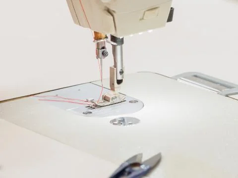 The process of sewing on the overlock in the garment shop. Foto stock