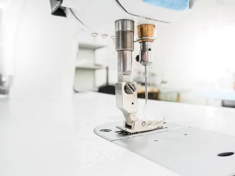 The process of sewing on the overlock in the garment shop. Stock Photos