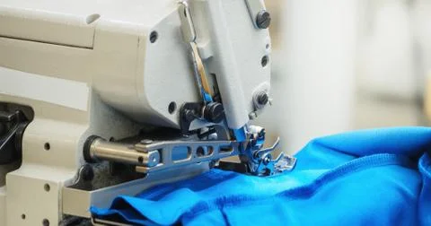The process of sewing on the overlock in the sewing shop. Stock Photos