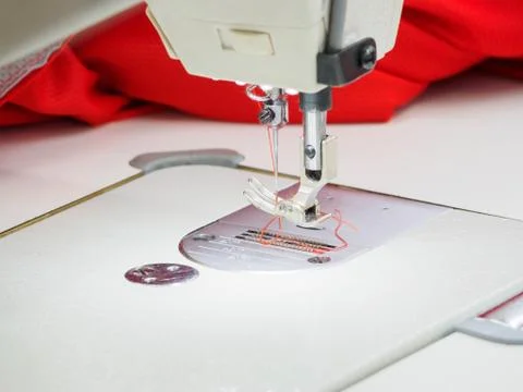 The process of sewing on the overlock in the sewing shop. Stock Photos