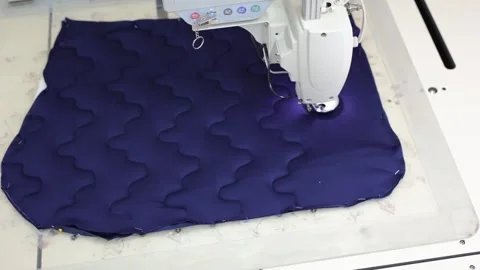 The process of sewing a pillow on a sewing machine. Stock Footage 309800453