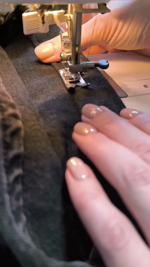 Process of sewing in a sewing machine sew woman's hands manicure black text.. Stock Footage 271034329