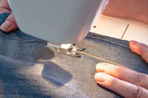 Process of sewing a stylish denim face mask, a hobby during COVID-19 pandemic. Stock Photos