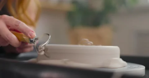 Process of shaping bowl border with a tool in a pottery studio. Female potter Stock Footage 155412428