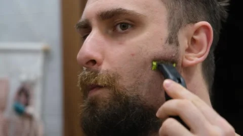 The process of shaving the beard close-up. A man shaves his beard close-up Stock Footage 232632750