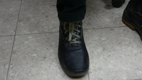 Process of shoes cleaning. Hand, brush and boot close up. mans hands brushing bl Stock Footage 99766697