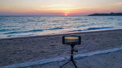 A process of shooting of sunset timelapse on mobile phone. Stock Photos