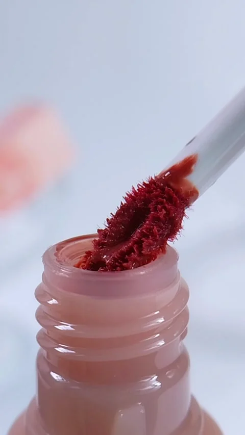 Process of showing a mini red brush being pulled out from pink cosmetic bot.. Stock Footage 340891140