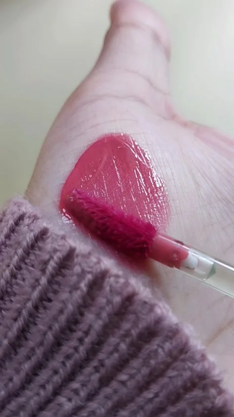Process of showing red lip tint color on palm using beauty brush applicator.. Stock Footage 339061920