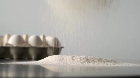 The process of sifting flour through a baking sieve in the kitchen against the Stock Footage 246491169