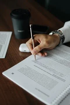 In the process of signing a document with a silver pen Stock Photos