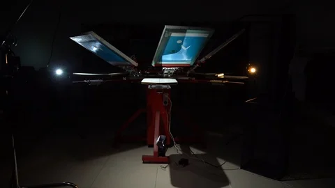 The process of silk screen printing on carousel in dark room Stock Footage 104543058