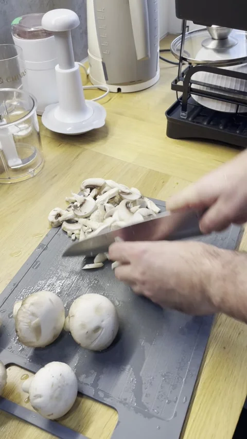 The process of slicing champignon mushrooms Video stock 329422879