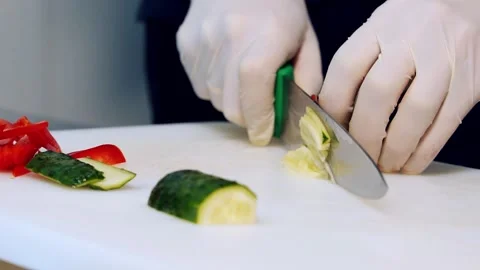 Process of slicing a cucumber. Chef's hands in gloves cut fresh cucumber 스톡 동영상 318310354