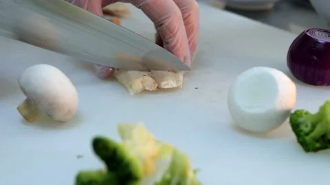 Process of slicing fish. Chef cuts the fish into small pieces with large knife Stock Footage 132427476