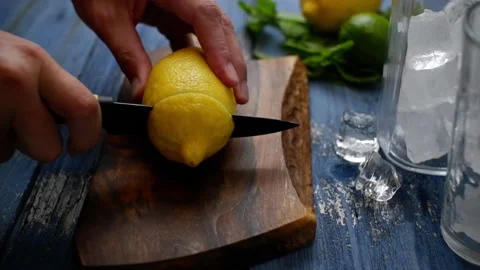 The process of slicing lemon for a refreshing drink with ice and mint. Stock Footage 155816188
