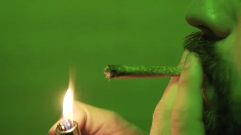 Process of smoking a close-up joint with marijuana  Stock Footage