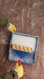 The process of soaking the roller in mortar Stock Photos