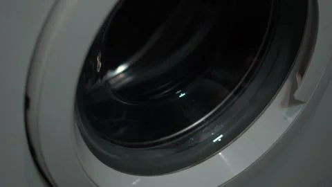 The process of spinning clothes in the drum of a washing machine Stock Footage 242600399