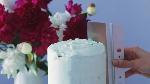 The process of spreading cream on the cake  using confectionery spatula. Stock Footage 105448109