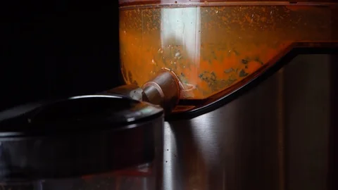 The process of squeezing the juice in the center of the juice extractor.Close-up Stock Footage 120253198