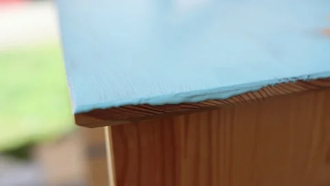 The process of staining the wooden surface with blue paint from jar Stock Footage 130169730