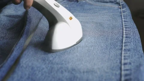 Process of steaming of jeans fabric using steamer Stock Footage 70368388