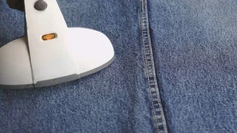 Process of steaming of jeans using steam cleaner Stock Footage 69181999